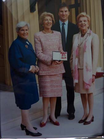 HP: Getting her CBE at Buckingham Palace, 2000