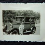 KM: With the family's first car, a small Opel, ca1931. "I put it into gear. And I used the starter. You see you- you didn't need an ignition key to work the starter; it had a button on the floor of the car. I put it in gear and each time the battery turned over the engine - car moved. So, I must have driven- gone about 100 yards with it. So, it was well down the street. [laughs] I had driven it. My father was not pleased. I seem to remember that."