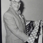 FB: Father at a menswear exhibition, "where we were showing off ties and bow ties," ca1974