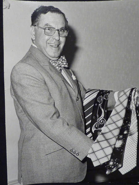 FB: Father at a menswear exhibition, "where we were showing off ties and bow ties," ca1974