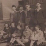 GJ: With other refugee children, Millisle Refugee Settlement Farm, County Down, Northern Ireland, 1943. "I am this person here, this lovely young boy, and they are the children together, we are being taken in front of the huts"