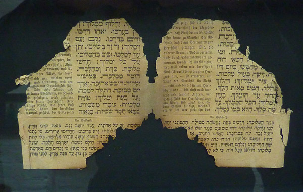 Two burnt pages of a prayer book, rescued by HD's father from the Oranienburgerstrasse Synagogue, Berlin, after Kristallnacht.
