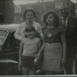 HG: With husband and daughters Yvonne and Monica in front of their first car, a Morris Minor, London, 1966