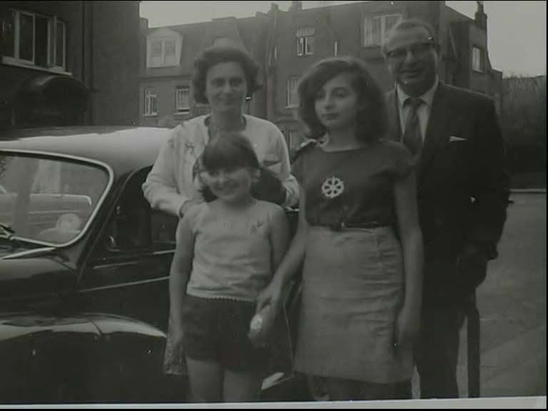 HG: With husband and daughters Yvonne and Monica in front of their first car, a Morris Minor, London, 1966