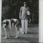 HG: Employer Mr Hunt during a wartime tennis party, with dog, gas mask and tin hat. "This is Mr Hunt at one of the Sunday afternoon tennis parties in the war, with the St Bernard dog, tin hat, gas mask and tennis racket. These afternoons took place quite often"