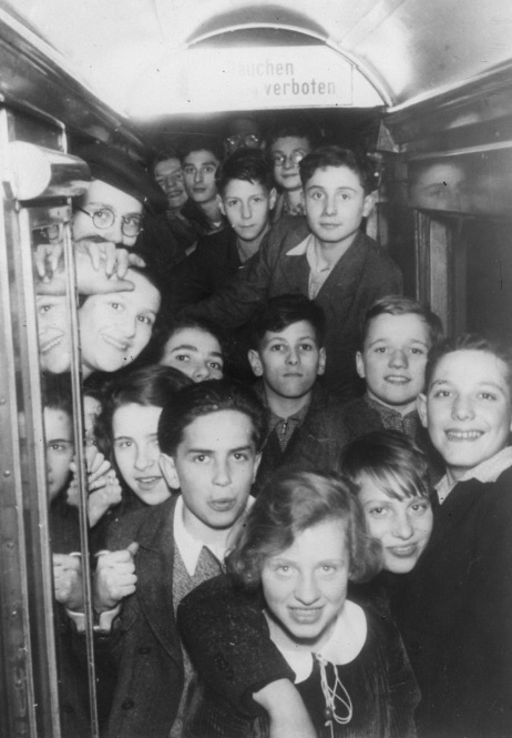 LB: Leslie on Kindertransport train, top centre, 1938. "here we have a group of children in the compartment of a German train, immediately after leaving Germany and crossing into Holland. This was posed for a Dutch photographer, who wanted to take this picture. And, apart from myself, there are at least two other boys who came from the Jewish orphanage. I am at the top centre of this picture, looking rather anxious, I must say. Despite the fact that we just crossed into safety, the German-Dutch border, I must say that I do look rather anxious and like a boy who doesn’t quite know what the future holds, which indeed I didn’t. "