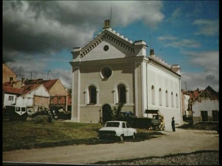 ES: Restored synagogue, Austerlitz, Slavkov, 1994. "And the synagogue when we first saw it was really very neglected and we had it renovated, and the town and the Ministry of culture in Prague managed to get enough funds to have it renovated and this was taken in 1994, shortly after the completion of the renovation. It’s a complete change and it looks beautiful now."
