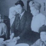 LL: Making Kiddush for Shabbat after liberation from Belsen with Mr. Birnbaum, his wife and family and others, 1945