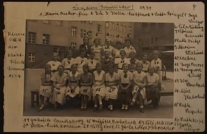 HS: Class at school, 1934. "And you see quite a number of the girls in white shirts and black skirts. They were girls in the Hitler Youth., maybe they were going on to a meeting or something. They wouldn’t necessarily wear it all the time. And as there was no school uniform they’re pretty obvious."