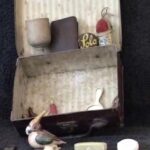 RE: Suitcase with possessions that Ruth brought to England in 1939. "This is a little Koffer which was mine which I brought with me with my own personal things, given to me by some people I cannot even remember - like a pencil sharpener like a frog, a needle case; one or two coins of Austrian money; a little bird that has a pin-cushion; a yo-yo that was given to me to learn to tie my shoes; a Hanukkah dreidl; a German dreidl. I think the Hanukkah one belonged to my grandfather, a knife that belonged to my father; an egg-cup that one of my uncles made during the war."