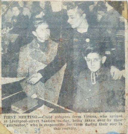 FK: Photograph taken by the Evening News photographer on the 15th of March 1939 showing Katie Cohen, who lived at 64 Old Church Street, collecting FK and his sister Claire. “That’s my sister Claire and myself, in the reception hall for the Kindertransport children who arrived on that date. Prior to going with us to 66 Old Church Street.”