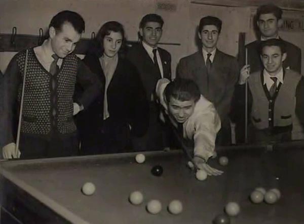 EF: EF with other members of the Primrose Youth Club. Most of these boys are concentration camp survivors celebrating the opening of a new house on Finchley Road for the club in 1952 with a game of snooker.