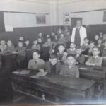 FK: FK’s class at Volkschule in Vienna, FK sitting next to Mr Adler, the teacher, 1937