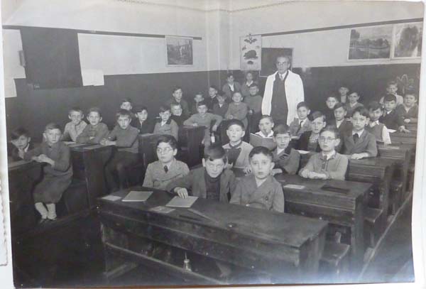 FK: FK’s class at Volkschule in Vienna, FK sitting next to Mr Adler, the teacher, 1937