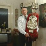 RL: "This Sefer Torah was written specially for my father's Bar Mitzvah, which took place in 1903. The Sofer, or scribe, wrote the different parts of the Torah in his hometown of Bromberg, to the East of Inowrocław, and each time a parchment piece was ready, he would bring it across the border to my father's house, who would pay him out in gold coins, my father kept telling me over the years, and eventually all the pieces were ready and the Sofer sewed them all together and made a Torah out of it. My father read from the Torah at his Bar Mitzvah. We were fortunate enough to bring the Torah out with us when we emigrated, and I read from the Torah at my Bar Mitzvah in 1939 and our two boys read from this Torah at their Bar Mitzvahs. Anthony was born in 1959, so that was 1972, and Jonathan in 1975. And, as you can see, it's still in my possession."