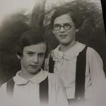 VM: With younger sister Doris, in their garden in London, 1936. "And I remember that shirt with the peter pan collar. It had been made for me especially in Germany before we left. And it was meant to be part of my school uniform, but of course the school uniform was with the ordinary white shirt. And having to wear this peter pan collar with my tunic was a decided embarrassment for many, many months."