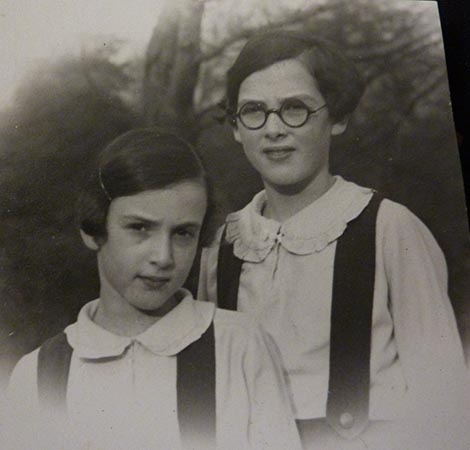 VM: With younger sister Doris, in their garden in London, 1936. "And I remember that shirt with the peter pan collar. It had been made for me especially in Germany before we left. And it was meant to be part of my school uniform, but of course the school uniform was with the ordinary white shirt. And having to wear this peter pan collar with my tunic was a decided embarrassment for many, many months."