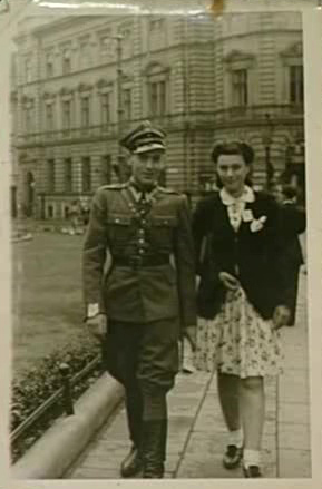 BK: Berta with her cousin, Eric Wasserberger, who was in the Polish Army, in front of the General Post Office in Bielsko-Biała where she worked as a telephone operator. On the left the town theatre. Spring 1946