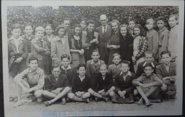 JD: Sitting on the ground to the right in his English class at the Ancient School boarding school he was sent to post war, ca 1947