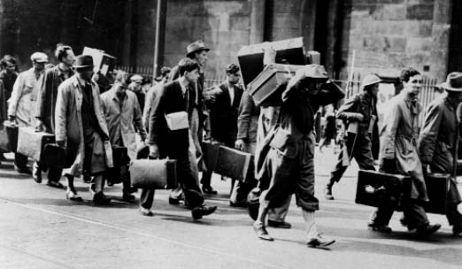 Refugees classed as 'enemy aliens' being marched to internment camps, summer 1940