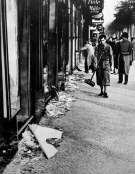 Jewish man forced to clear up broken glass after Kristallnacht